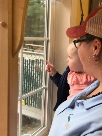 toddler_and_teacher_looking_out_the_window_cadence_academy_preschool_smithfield_ri-338x450