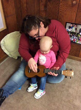 toddler_and_teacher_playing_guitar_cadence_academy_preschool_urbandale_ia-333x450