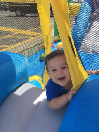 toddler_boy_enjoying_bounce_house_prime_time_early_learning_centers_farmingdale_ny-338x450