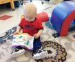 toddler_boy_reading_plush_book_at_cadence_academy_preschool_mount_pleasant_sc-547x450