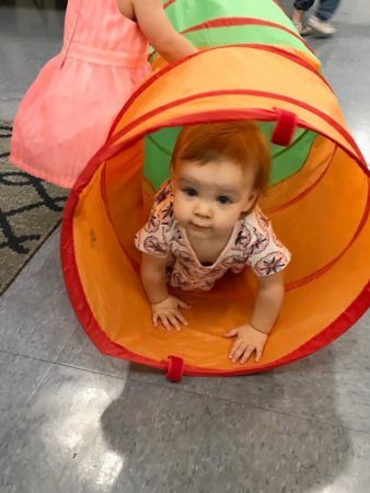 toddler_crawling_through_tunnel_jonis_child_care_and_preschool_hartford_ct-338x450