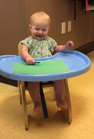 toddler_drawing_in_high_chair_creative_expressions_learning_center_eureka_mo-307x450