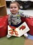 toddler_enjoy_cozy_red_lounge_chair_creative_expressions_learning_center_imperial_mo-333x450