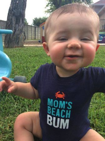 toddler_enjoying_grass_cadence_academy_preschool_frisco_tx-336x450