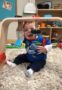 toddler_enjoying_playing_with_hanging_toys_cadence_academy_preschool_tualatin_or-311x450