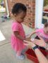 toddler_getting_seeds_to_plant_carolina_kids_child_development_center_rock_hill_sc-338x450