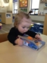 toddler_girl_amazed_by_fish_book_cadence_academy_preschool_tacoma_wa-336x450
