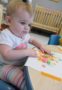 toddler_girl_doing_fingerpaint_cadence_academy_preschool_johnston_ia-308x450