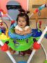 toddler_girl_in_bouncer_and_painting_with_feet_at_next_generation_childrens_centers_westborough_ma-333x450