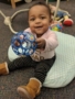 toddler_girl_offering_ball_rogys_learning_place_hilltop_peoria_il-338x450