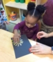 toddler_girl_painting_with_cardboard_tube_brush_growing_kids_academy_fredericksburg_va-384x450