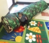 toddler_girl_playing_in_tunnel_at_cadence_academy_preschool_lexington_sc-517x450