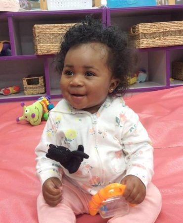 toddler_girl_playing_with_toys_on_mat_rogys_learning_place_east_peoria_il-370x450