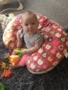 toddler_girl_playing_with_toys_while_sitting_on_lounging_cushion_cadence_academy_preschool_milwaukie_portland_or-338x450