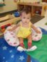 toddler_girl_sitting_in_lounge_cushion_cadence_academy_preschool_centennial_co-338x450