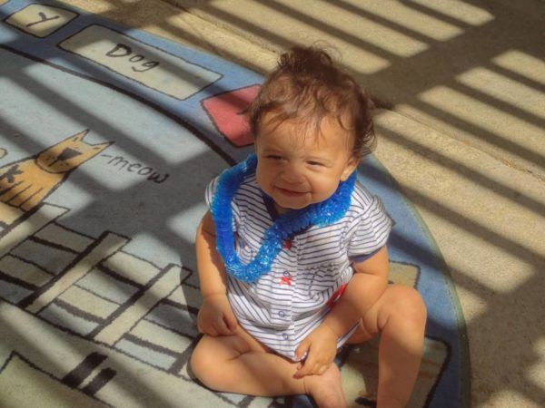 toddler_girl_wearing_lei_cadence_academy_preschool_farmers_market_sacramento_ca-600x450