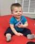 toddler_holding_dolphin_toy_rogys_learning_place_east_peoria_il-365x450