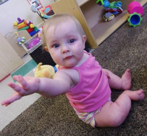 toddler_holding_out_hand_cadence_academy_preschool_centennial_co-488x450