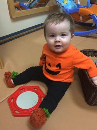 toddler_in_pumpkin_outfit_cadence_academy_chesterfield_mo-335x450