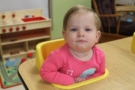 toddler_in_seat_at_table_learning_edge_childcare_and_preschool_oak_creek_wi-676x450