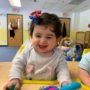 toddler_laughing_in_seat_creative_kids_childcare_centers_yorktown-450x450