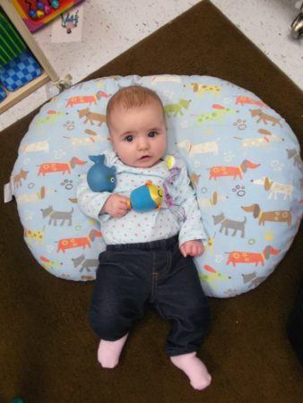toddler_on_lounging_pillow_cadence_academy_preschool_johnston_ia-338x450