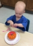 toddler_painting_a_pumpkin_cadence_academy_preschool_urbandale_ia-330x450