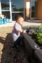 toddler_playing_in_garden_at_smaller_scholars_montessori_academy_gilbert_az-299x450