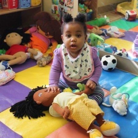 toddler_playing_with_doll_cadence_academy_cordova_tn-450x450