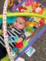 toddler_playing_with_hanging_toys_cadence_academy_preschool_milwaukie_portland_or-338x450