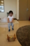 toddler_playing_with_lawn_mower_toy_smaller_scholars_montessori_academy_gilbert_az-300x450