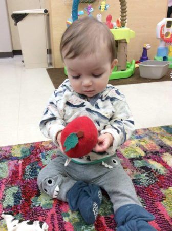 toddler_playing_with_tomato_toy_cadence_academy_preschool_iowa_city_ia-336x450