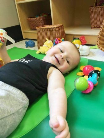 toddler_playing_with_toys_and_smiling_gateway_academy_mckee_charlotte_nc-338x450