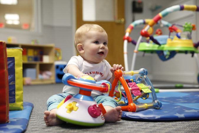 toddler_playing_with_toys_on_carpet_winwood_childrens_center_leesburg_va-675x450
