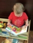 toddler_reading_a_book_sunbrook_academy_at_woodstock_ga-338x450