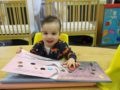 toddler_reading_large_book_winwood_childrens_center_fairfax_va-600x450