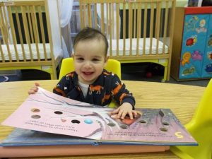 toddler_reading_large_book_winwood_childrens_center_fairfax_va-600x450
