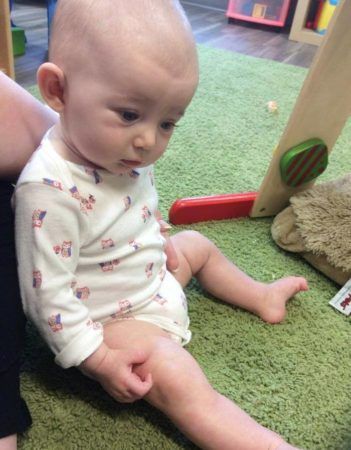 toddler_sitting_up_on_floor_cadence_academy_preschool_cooper_point_olympia_wa-351x450