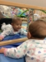 toddler_smiling_at_herself_in_mirror_at_cadence_academy_preschool_cypress_houston_tx-333x450