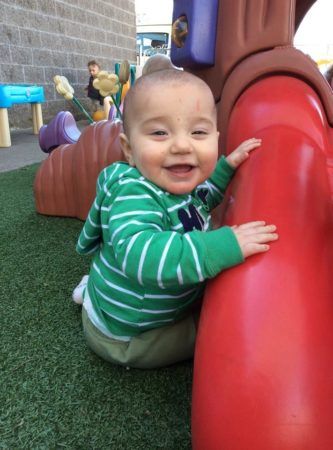 toddler_smiling_on_playground_rogys_learning_place_east_peoria_il-333x450