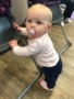 toddler_standing_next_to_high_chair_at_cadence_academy_preschool_broomfield_co-338x450