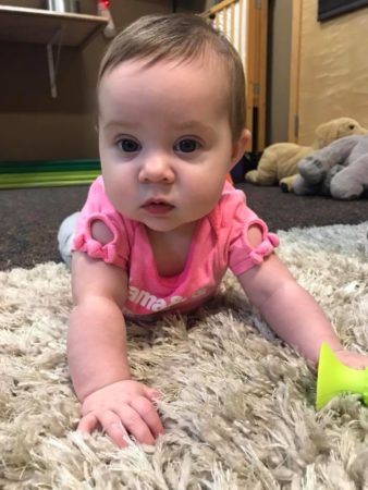 toddler_tummy_time_on_soft_carpet_cadence_academy_preschool_sellwood_portland_or-338x450