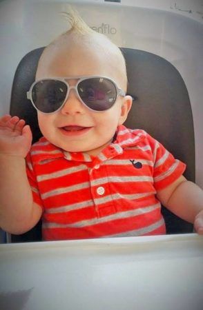 toddler_with_sunglasses_in_high_chair_cadence_academy_preschool_surfside_myrtle_beach_sc-294x450