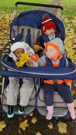 toddlers_going_for_ride_in_stroller_cadence_academy_preschool_brentwood_portland_or-253x450