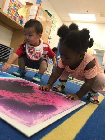 toddlers_playing_with_color_board_winwood_childrens_center_gainesville_ii_va-338x450