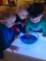 toddlers_playing_with_liquid_and_light_box_bearfoot_lodge_private_school_wylie_tx-338x450