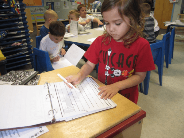 writing_activity_during_kindergarten_club_cadence_academy_preschool_main_street_normal_il-600x450