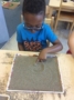 writing_letters_in_sand_activity_cadence_academy_preschool_tumwater_wa-336x450