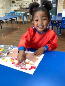 a child doing crafts indoors