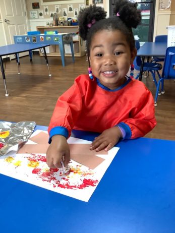 a child doing crafts indoors